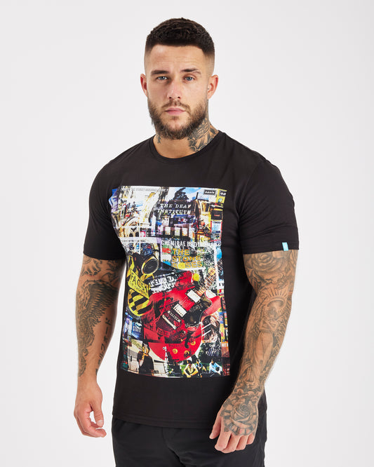 Hacienda Tee - Black. A black t-shirt with a colorful pop art design of the iconic Hacienda nightclub in Manchester, England. The design features the club's name and logo, as well as images of people dancing and partying.